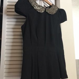 Black top with golden sequin collar.